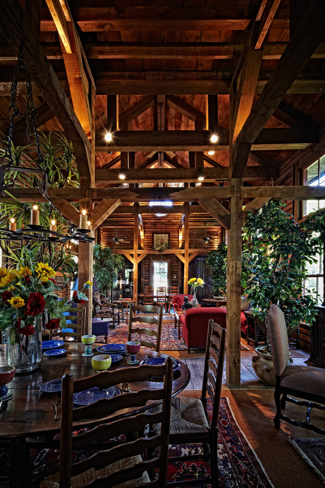 Cette photo montre un salon nature de taille moyenne et ouvert avec parquet foncé, une cheminée standard, un manteau de cheminée en brique, aucun téléviseur et un sol marron.