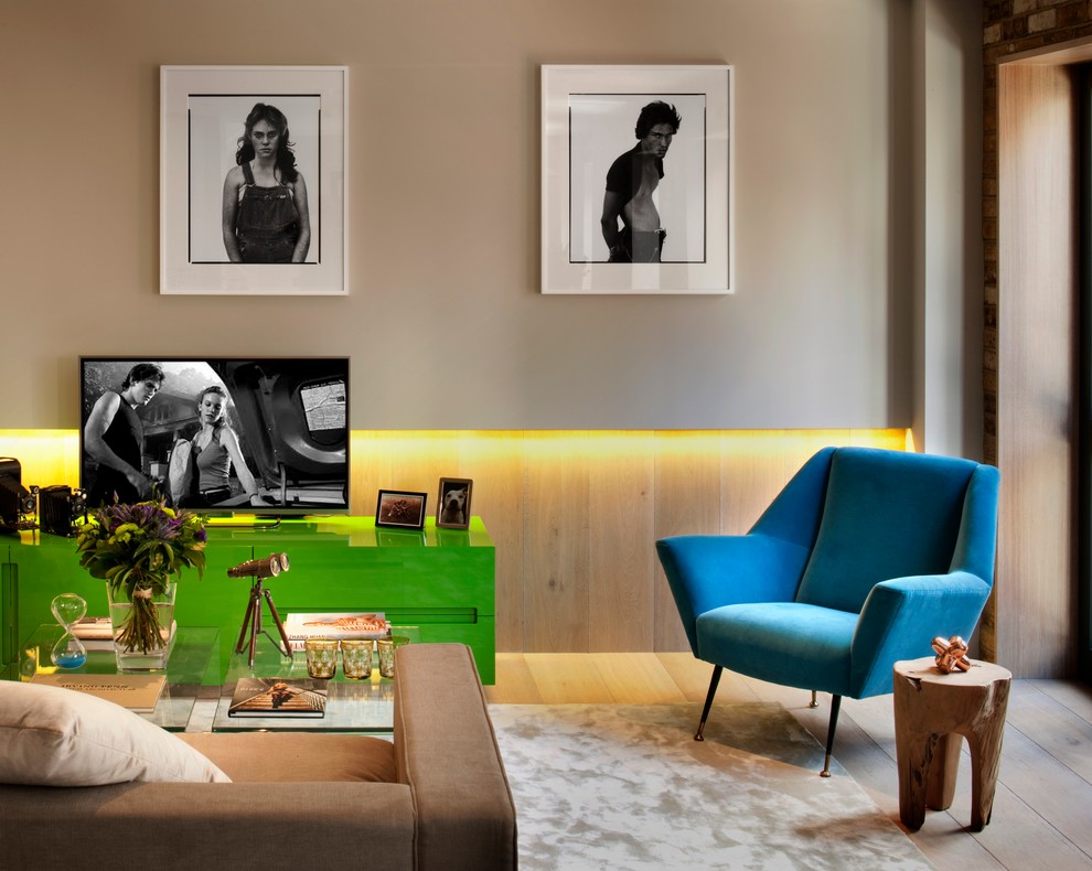 Mid-sized trendy light wood floor living room photo in London with beige walls and a tv stand