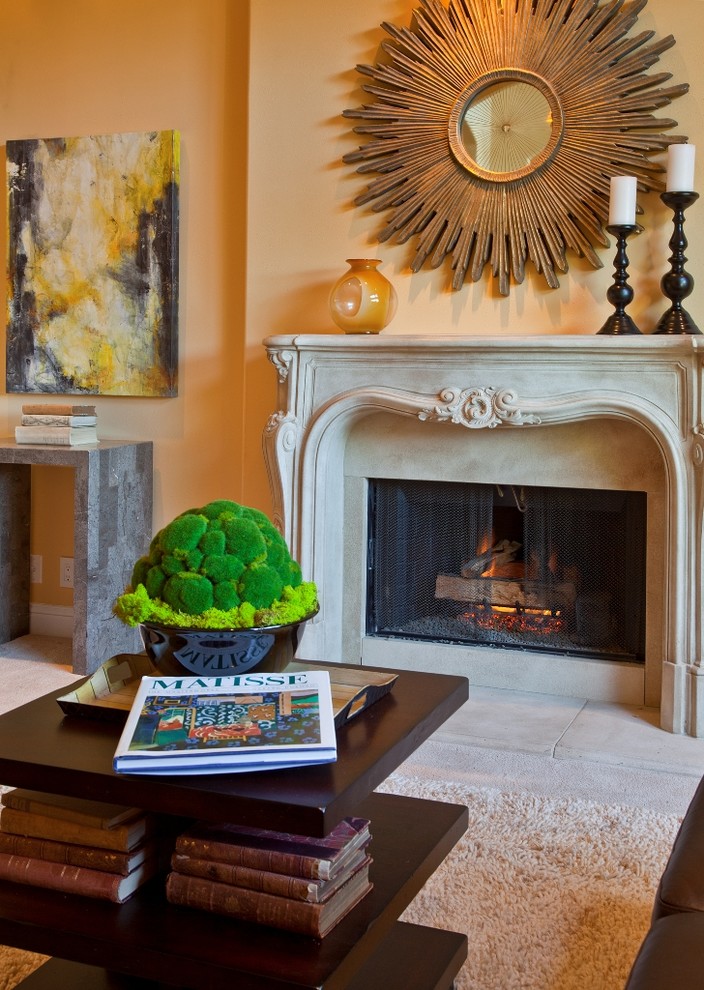 Exemple d'un salon chic avec un mur orange et un manteau de cheminée en pierre.