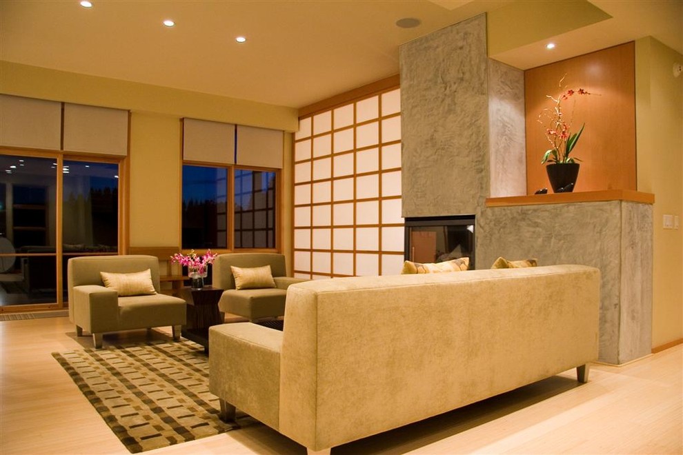 Inspiration for a contemporary living room in Sacramento with a concrete fireplace surround.