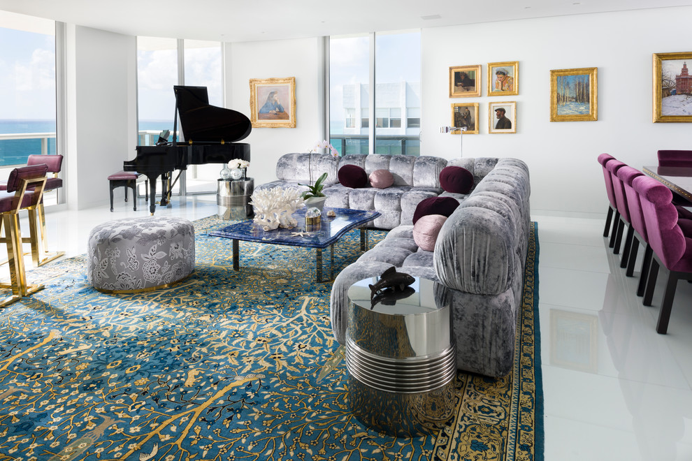 This is an example of a contemporary open plan living room in Miami with white walls and white floors.
