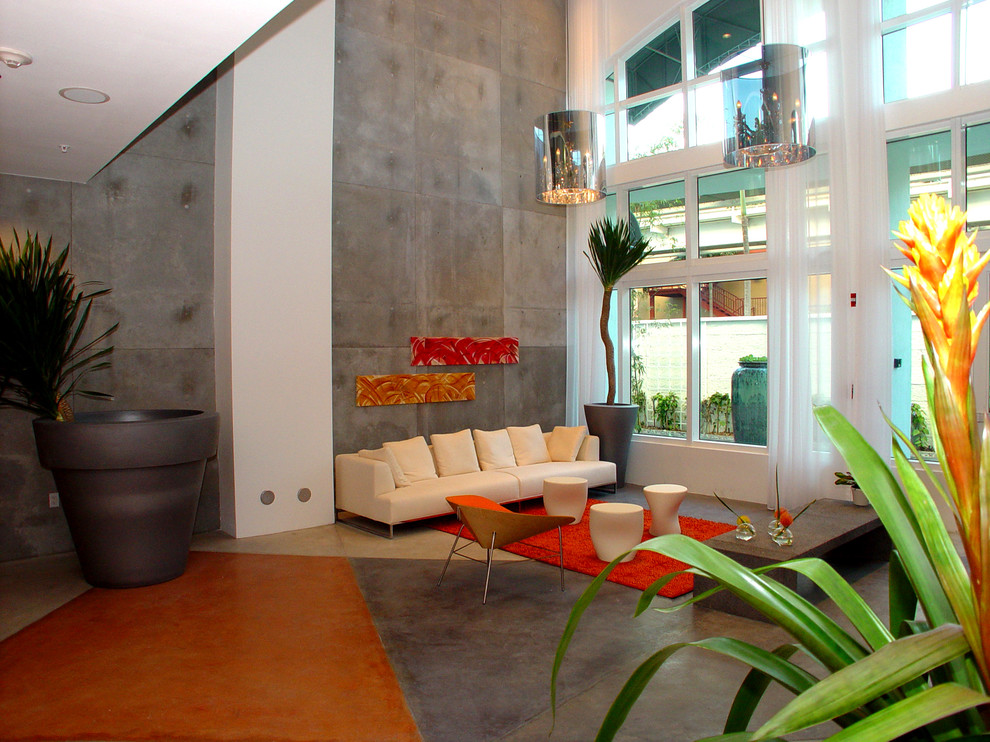 Inspiration pour un grand salon design ouvert avec une salle de réception, un mur gris et sol en béton ciré.