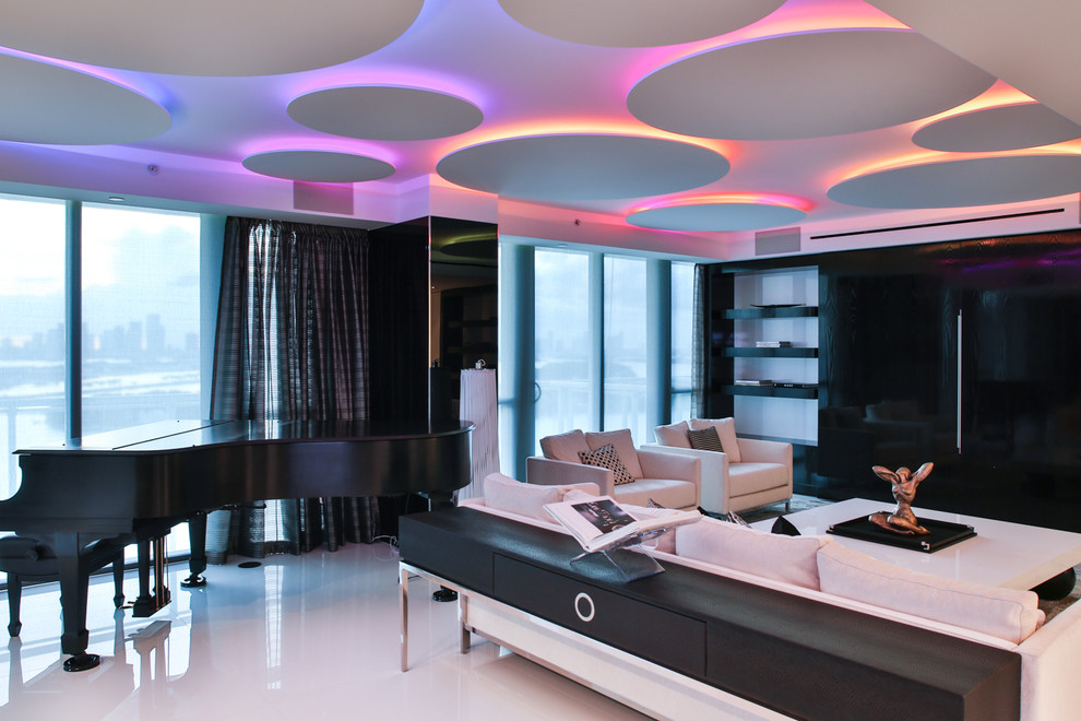 Example of a large trendy formal and open concept marble floor living room design in Miami with white walls and a media wall