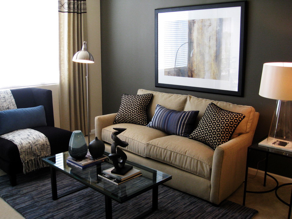 Photo of a contemporary grey and teal living room in San Diego with grey walls and feature lighting.