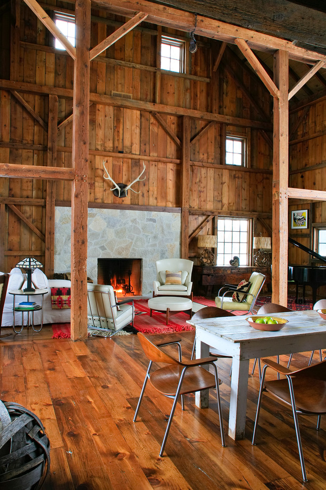 Example of a mountain style living room design in Detroit with a stone fireplace