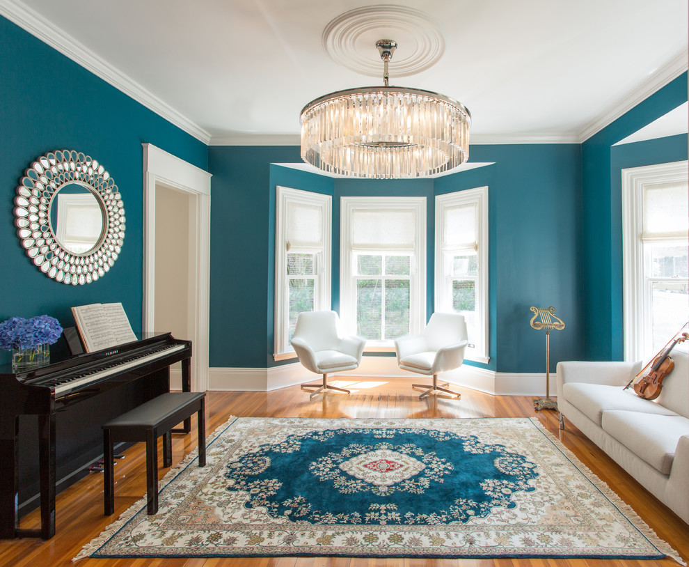 Ejemplo de salón con rincón musical cerrado tradicional renovado de tamaño medio sin chimenea con paredes azules, suelo de madera en tonos medios y alfombra