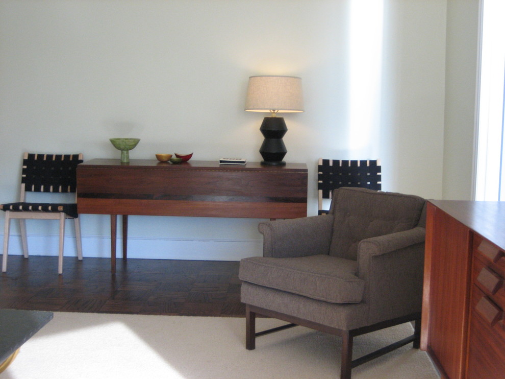 Foto di un piccolo soggiorno moderno aperto con pareti verdi, parquet scuro e TV a parete