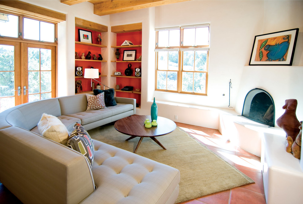 Medium sized retro open plan living room in Albuquerque with white walls, terracotta flooring, a corner fireplace and a plastered fireplace surround.