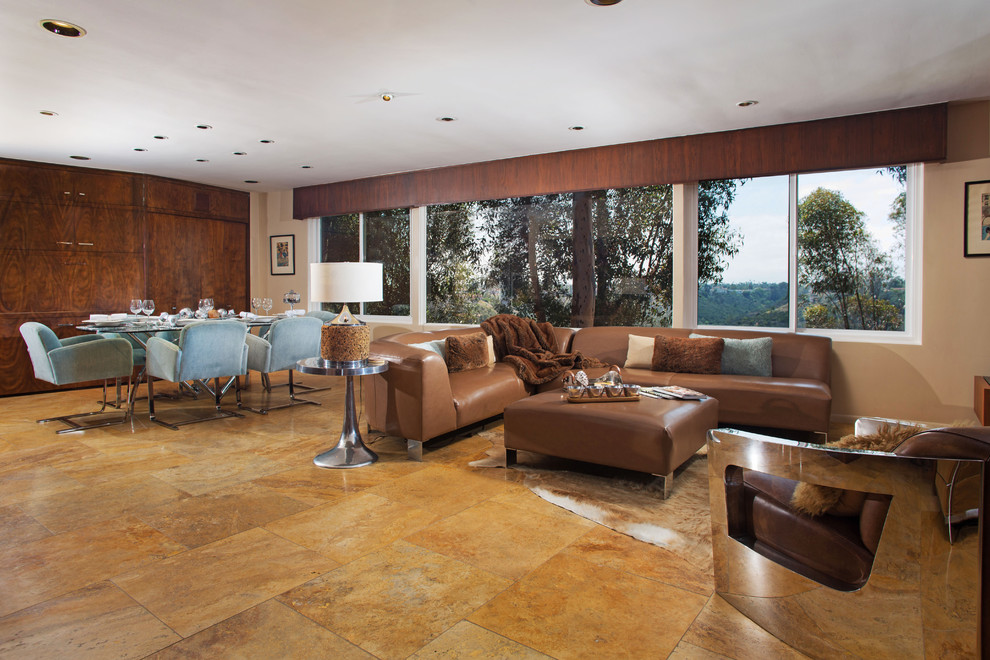 Expansive retro formal open plan living room in San Diego with beige walls, travertine flooring, a stone fireplace surround and a wall mounted tv.