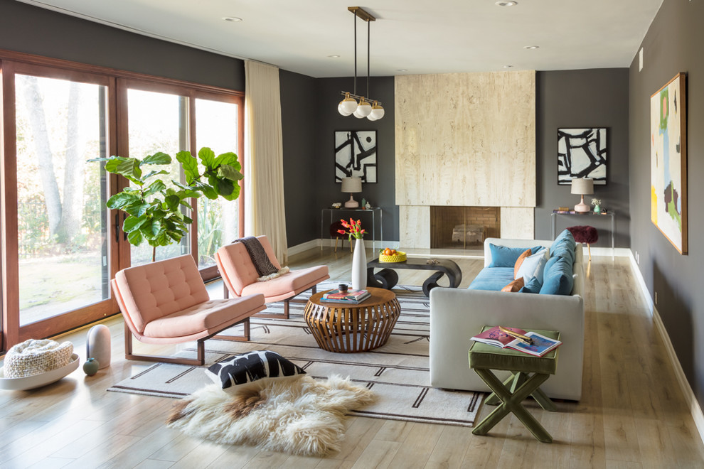 Example of an eclectic light wood floor living room design in Los Angeles with gray walls