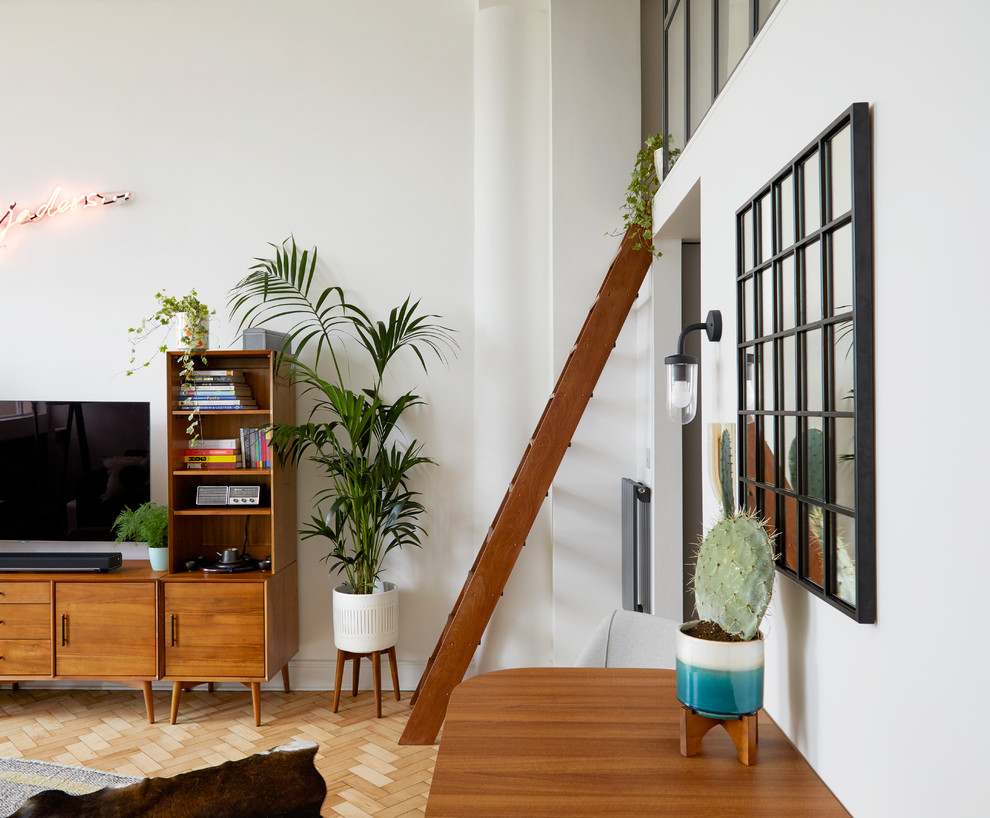 Mittelgroßes Retro Wohnzimmer im Loft-Stil mit weißer Wandfarbe, braunem Holzboden, freistehendem TV und beigem Boden in London