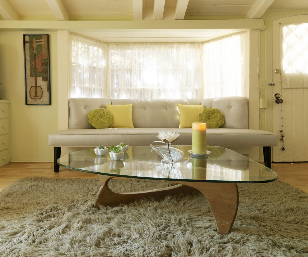 Living room - small mid-century modern enclosed medium tone wood floor living room idea in Los Angeles with green walls