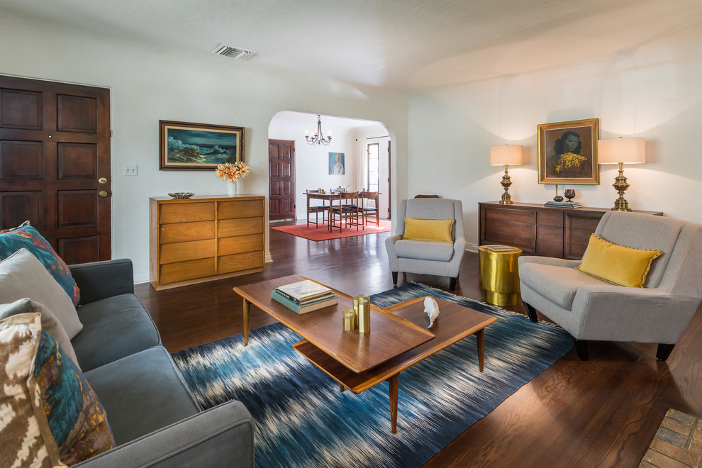 Inspiration for a classic enclosed living room in Los Angeles with dark hardwood flooring, no fireplace, no tv, brown floors and feature lighting.