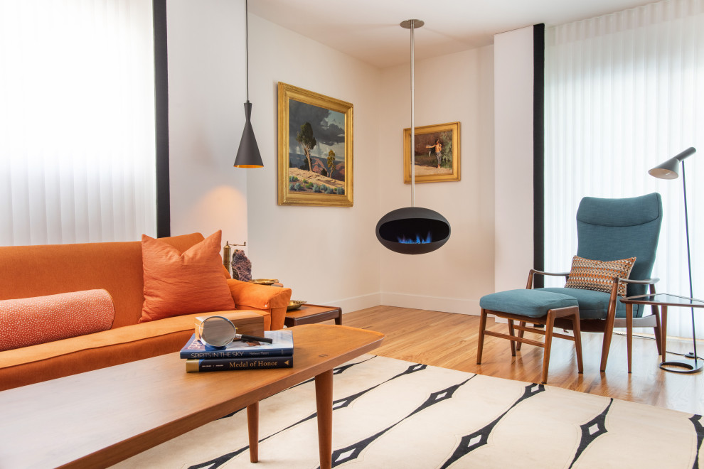 Стильный дизайн: гостиная комната в стиле ретро с подвесным камином - последний тренд