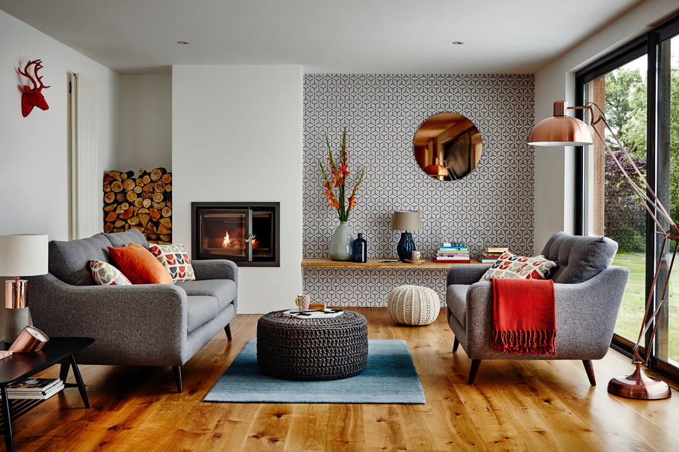 Design ideas for a retro living room in Other with a metal fireplace surround and brown floors.