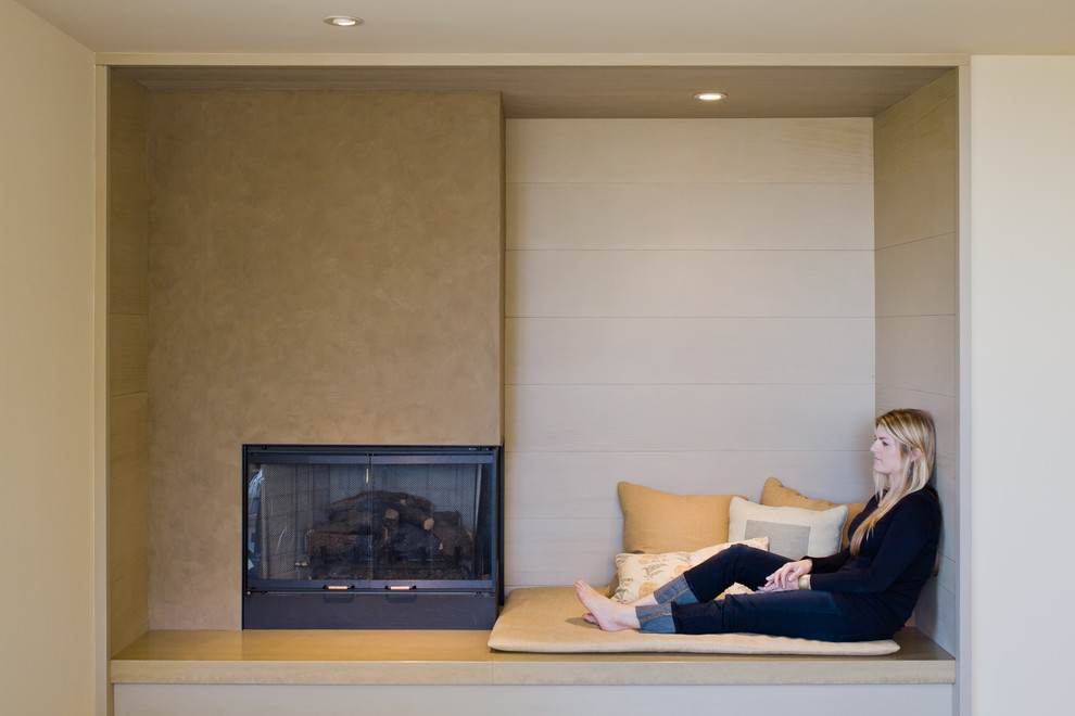Living room - large modern open concept living room idea in San Francisco with beige walls and a standard fireplace