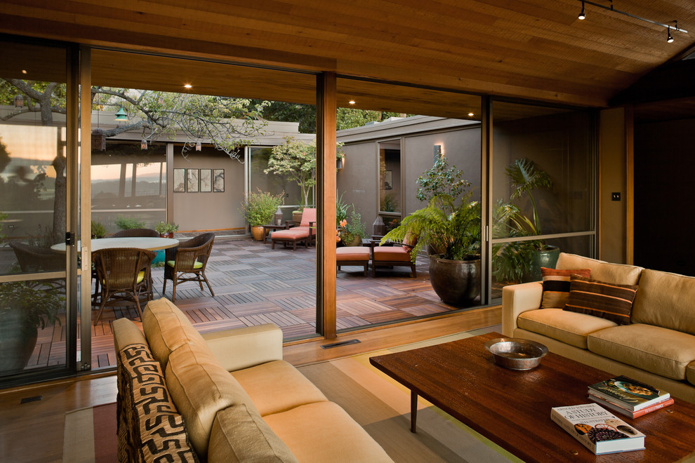Example of a large trendy open concept medium tone wood floor living room design in San Francisco with beige walls