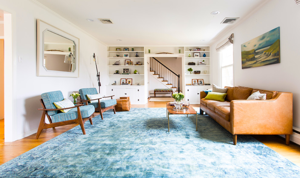 Large traditional grey and teal enclosed living room in Philadelphia with white walls, medium hardwood flooring and no tv.