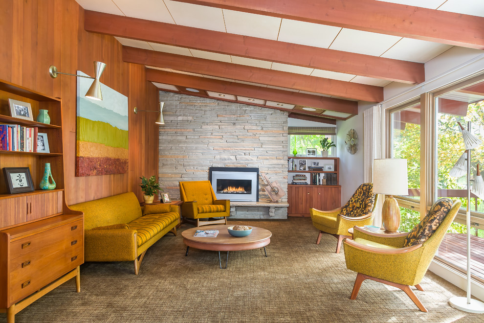 Photo of a midcentury formal living room in Minneapolis with white walls, carpet, a standard fireplace and a stone fireplace surround.