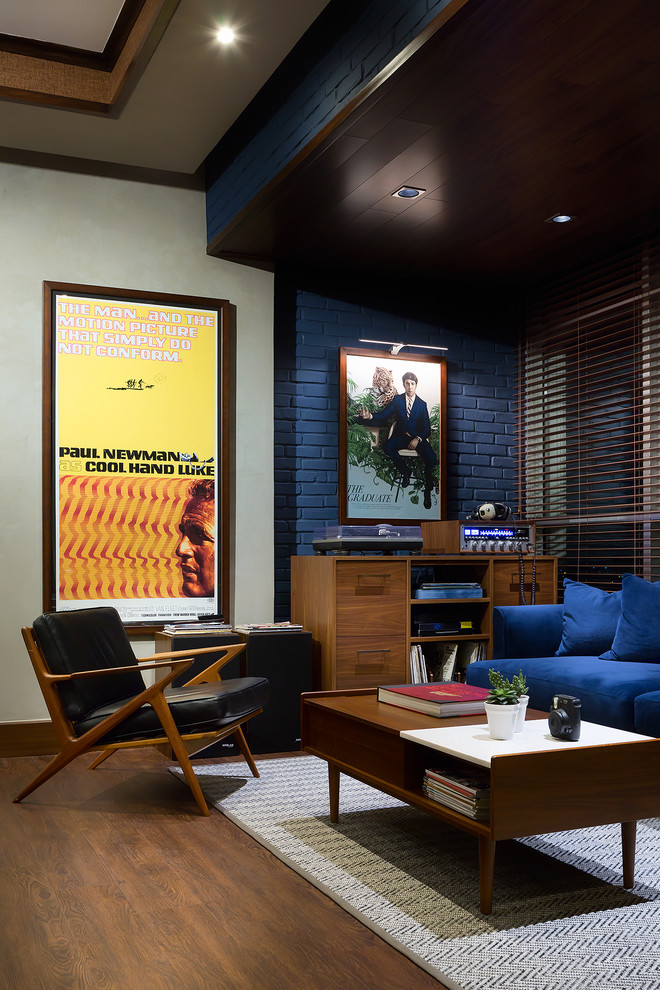 Inspiration for a mid-sized 1950s loft-style laminate floor and brown floor living room remodel in Other with a music area, blue walls, no fireplace, a brick fireplace and no tv