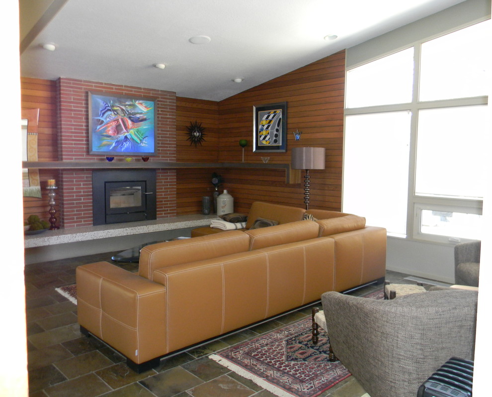 This is an example of a medium sized retro open plan living room in Other with slate flooring, a wood burning stove and a brick fireplace surround.