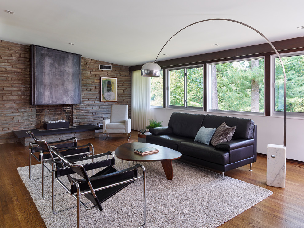 Design ideas for a medium sized midcentury formal open plan living room in Philadelphia with light hardwood flooring, a standard fireplace, a metal fireplace surround, brown walls and brown floors.