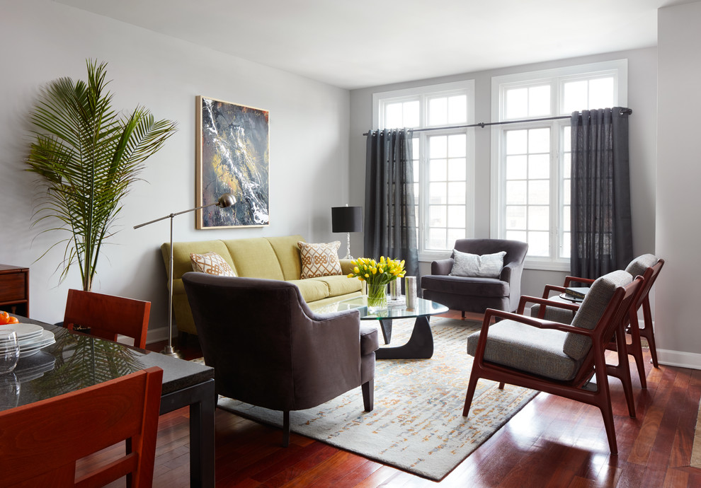 Midcentury open plan living room in Chicago with grey walls and medium hardwood flooring.