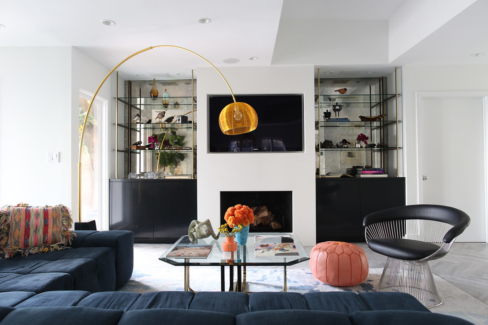 Design ideas for a retro living room in Los Angeles with white walls, a standard fireplace and a built-in media unit.