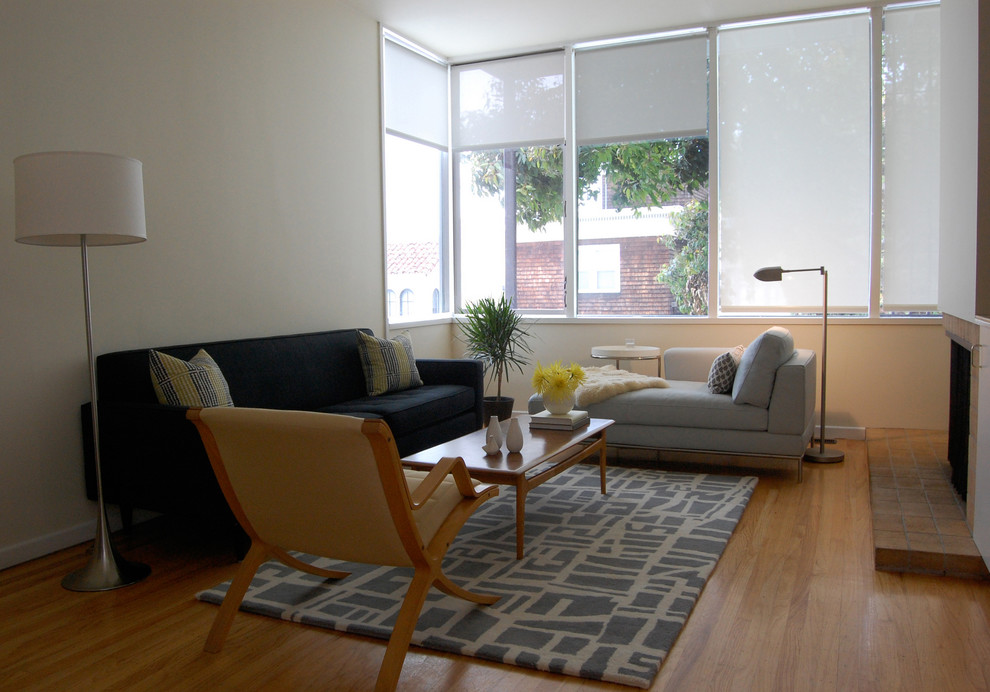 Example of a 1960s living room design in San Francisco with a standard fireplace