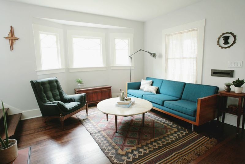 This is an example of a small midcentury formal enclosed living room in Los Angeles with dark hardwood flooring, no fireplace, no tv, white walls and brown floors.