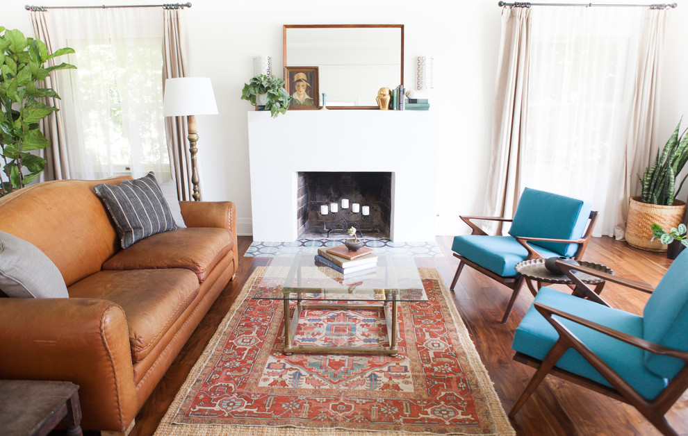 Mid-sized 1950s formal medium tone wood floor living room photo in Los Angeles with white walls and a standard fireplace