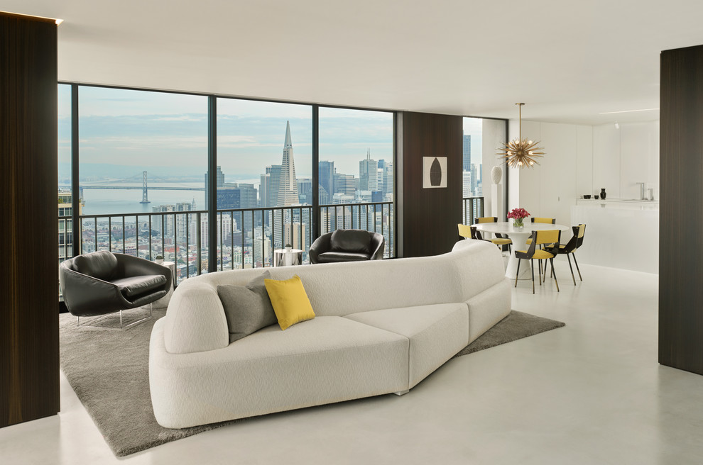 Ispirazione per un piccolo soggiorno moderno aperto con angolo bar, pareti marroni, pavimento in cemento e TV nascosta