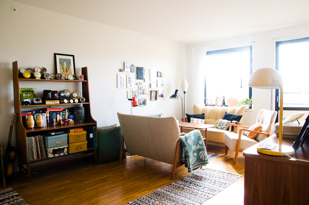 Inspiration for a mid-sized mid-century modern enclosed medium tone wood floor living room remodel in Other with white walls, no fireplace and no tv