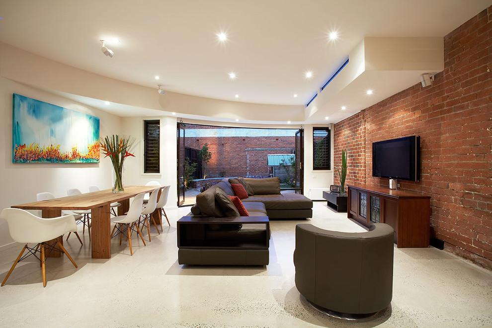 Large contemporary open plan living room in Melbourne with no fireplace, white walls and a wall mounted tv.
