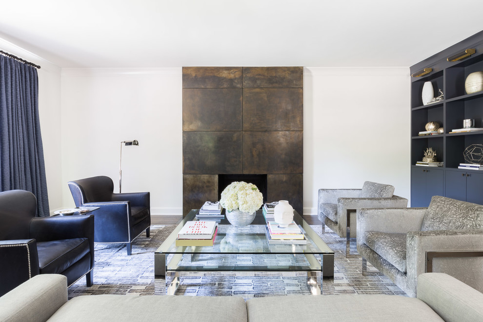 Immagine di un grande soggiorno design aperto con sala formale, pareti bianche, parquet scuro, camino classico e pavimento marrone