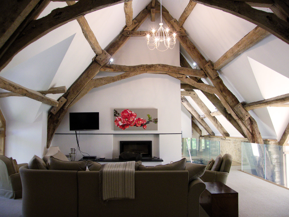 Immagine di un grande soggiorno country stile loft con pareti bianche, moquette, camino classico e TV a parete