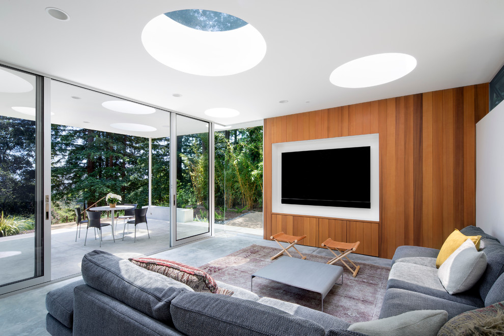 This is an example of a contemporary living room in San Francisco with white walls and a wall mounted tv.