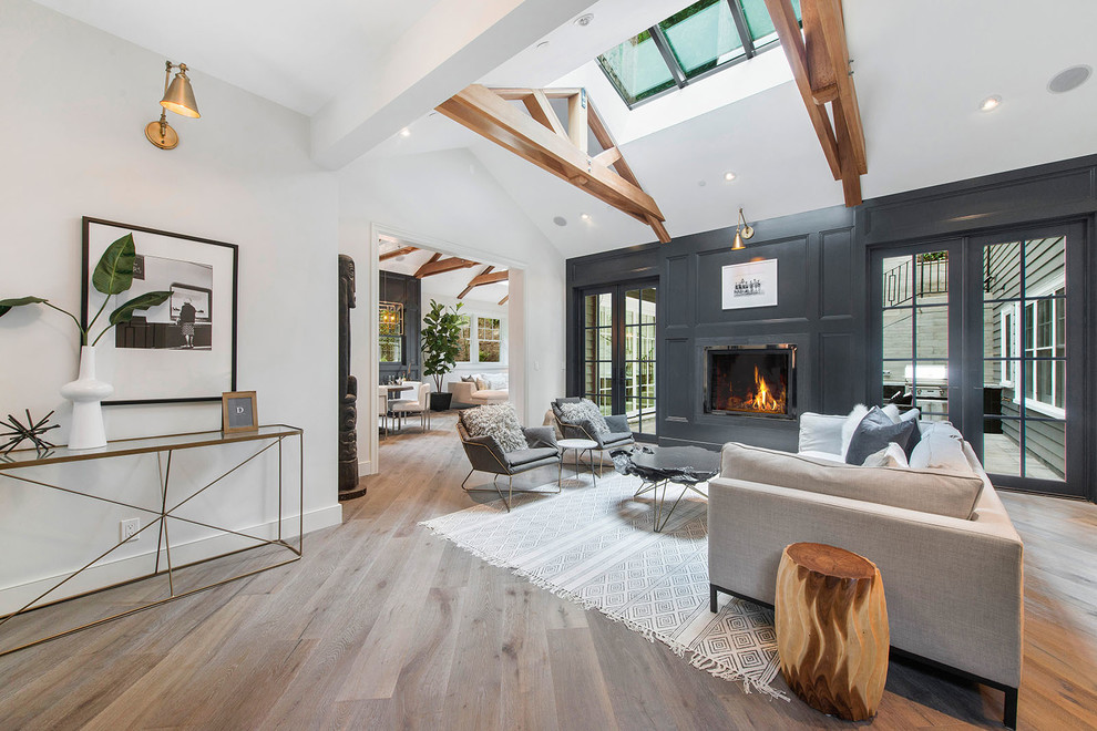 Inspiration for a mid-sized transitional formal and open concept light wood floor and beige floor living room remodel in San Francisco with white walls, a standard fireplace, a metal fireplace and no tv