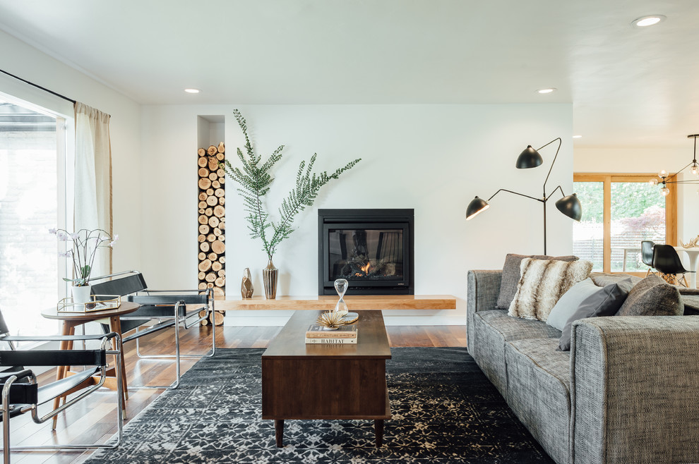 Photo of a large contemporary open plan living room in Salt Lake City with white walls, dark hardwood flooring, a standard fireplace, a plastered fireplace surround, no tv and brown floors.