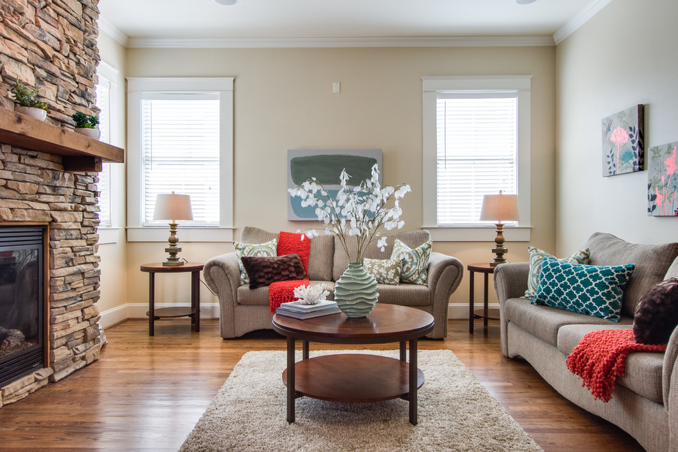 На фото: гостиная комната в классическом стиле с бежевыми стенами и коричневым диваном