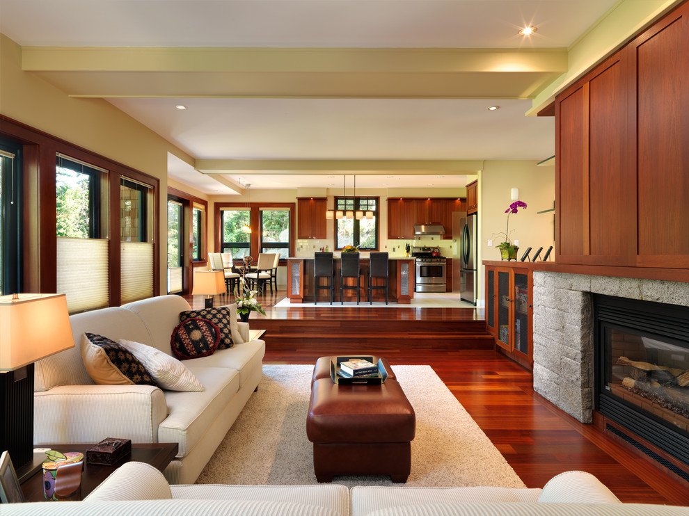 Стильный дизайн: открытая гостиная комната в классическом стиле с бежевыми стенами и стандартным камином - последний тренд