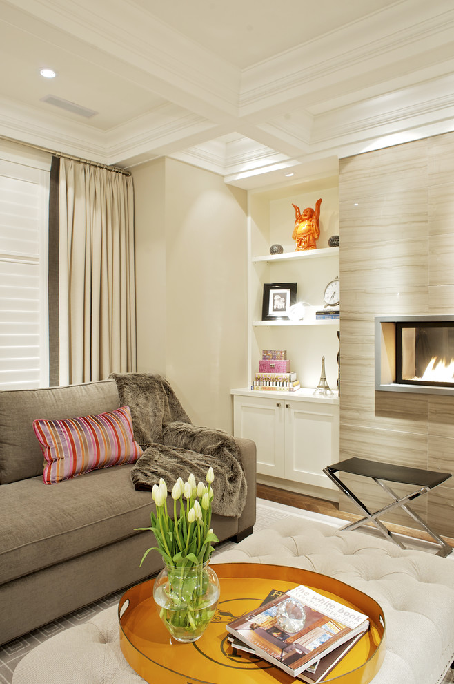 This is an example of a large contemporary enclosed living room curtain in Toronto with beige walls, a ribbon fireplace, light hardwood flooring and a stone fireplace surround.