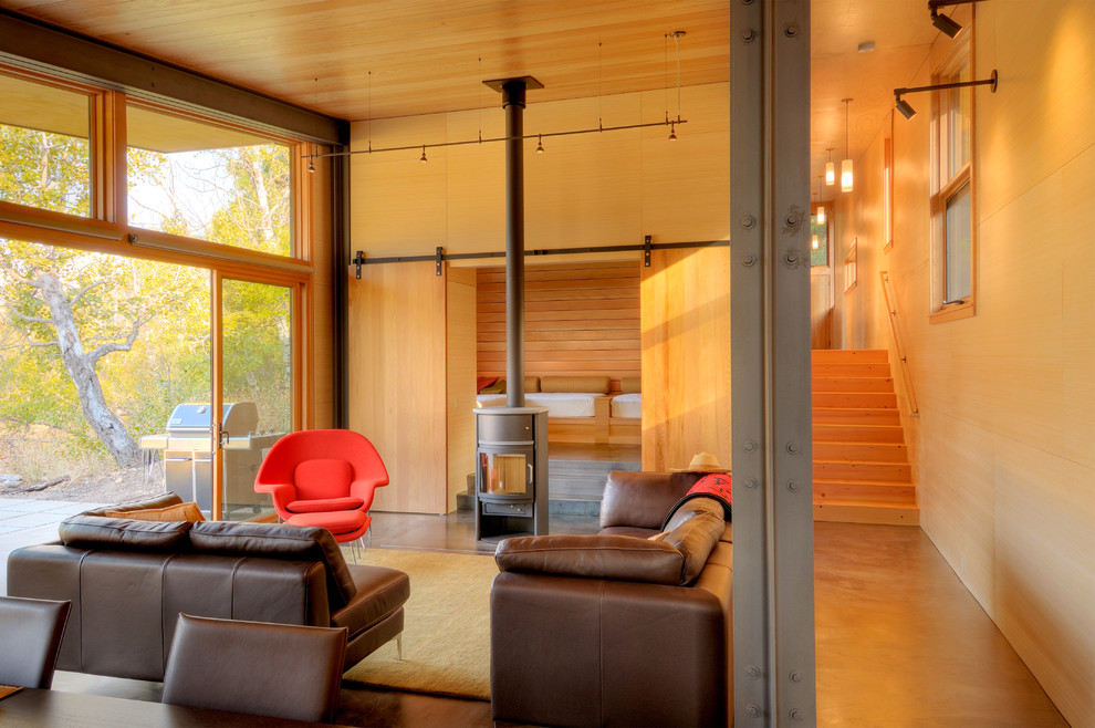 Living room - small contemporary formal and enclosed living room idea in Seattle with beige walls, a wood stove, a metal fireplace and no tv