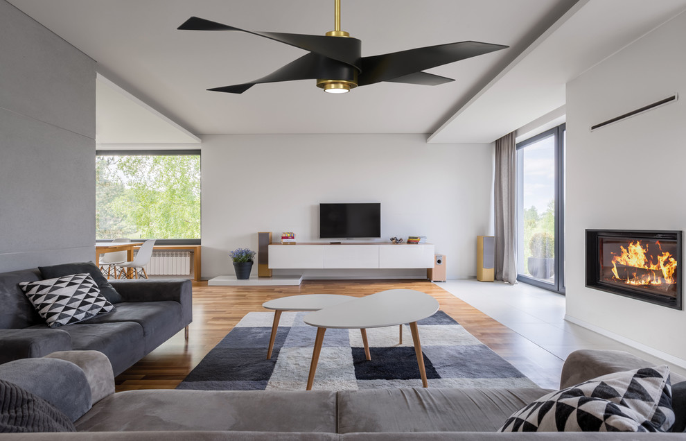 Idee per un soggiorno design con camino classico e TV autoportante