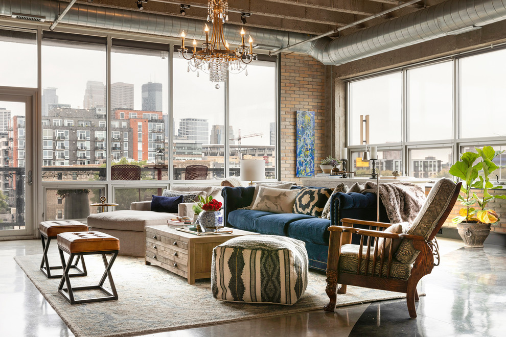 This is an example of a large eclectic mezzanine living room in Minneapolis with blue walls, concrete flooring, a standard fireplace, a tiled fireplace surround and grey floors.