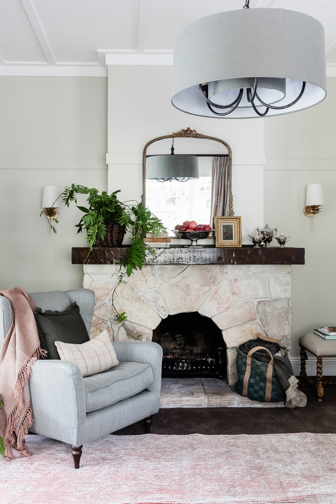 Inspiration for a large eclectic enclosed carpeted living room remodel in Sydney with beige walls, a standard fireplace, a stone fireplace and no tv
