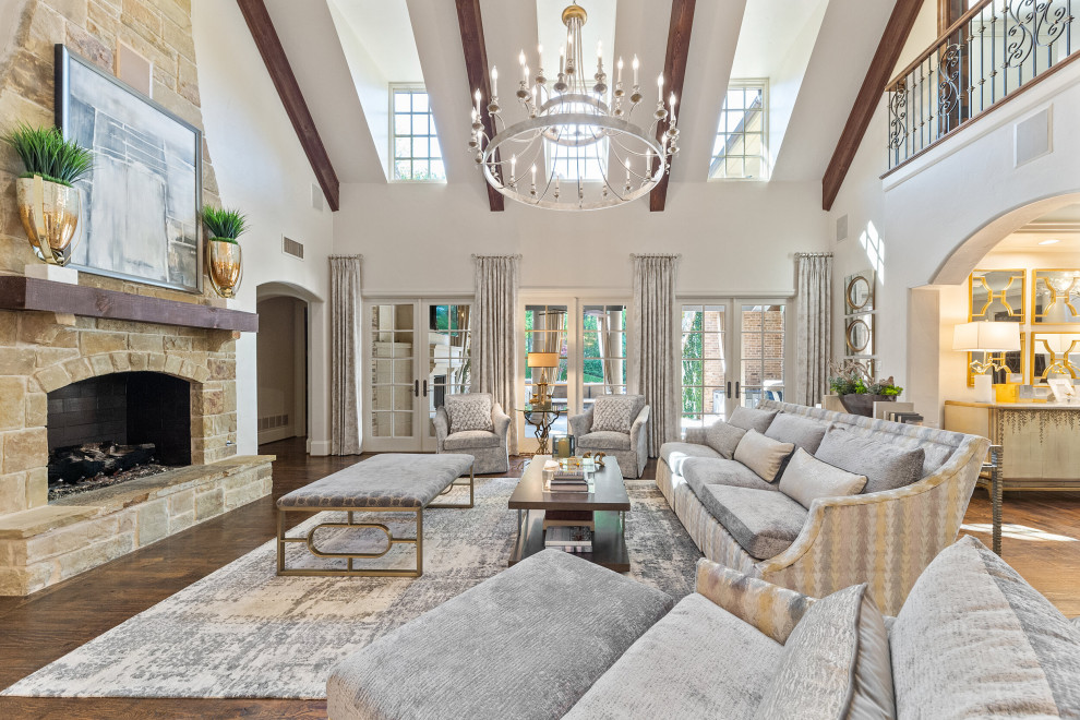Inspiration for a transitional open concept dark wood floor, brown floor, exposed beam and vaulted ceiling living room remodel in Dallas with white walls, a standard fireplace and a stone fireplace