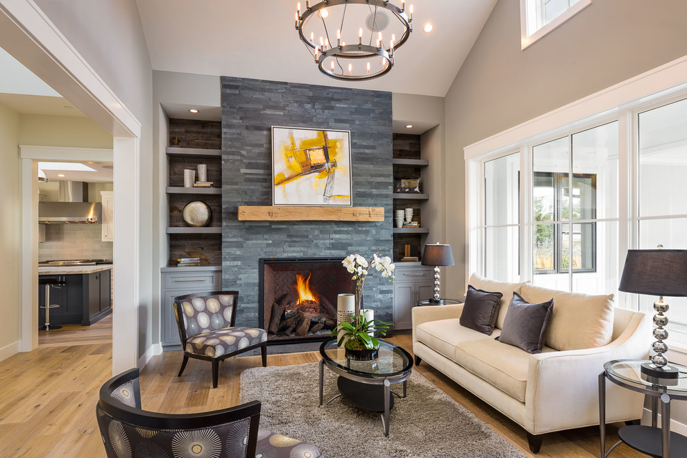 Mid-sized transitional formal and open concept medium tone wood floor and brown floor living room photo in San Francisco with a standard fireplace and gray walls