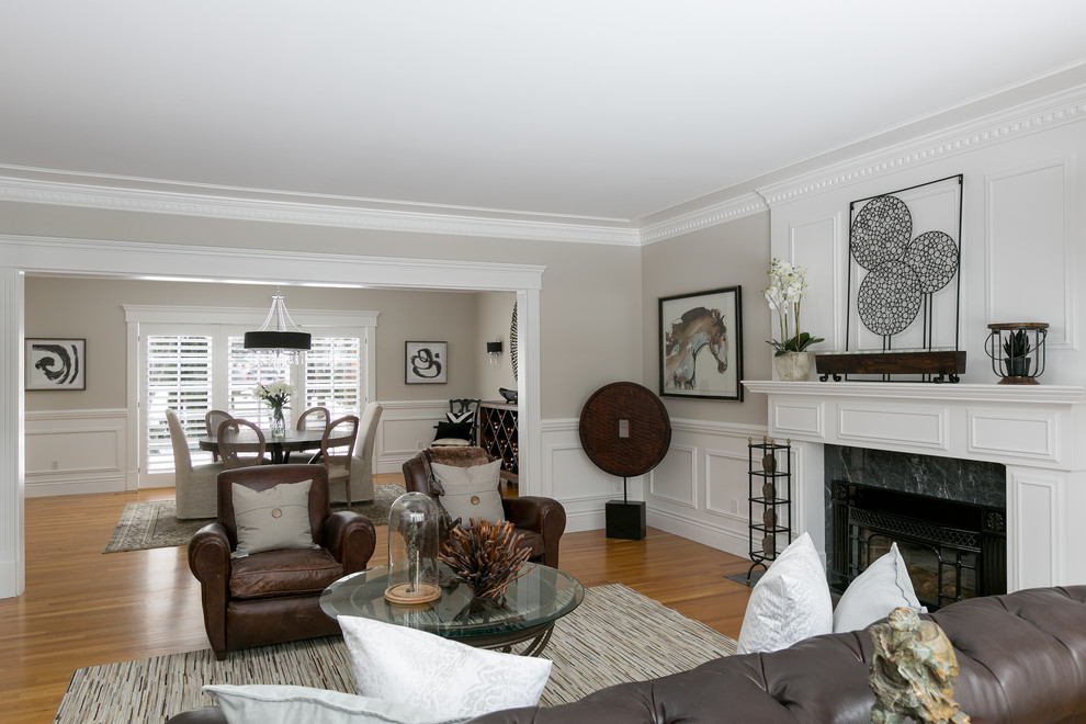 Large classic enclosed living room in Vancouver with grey walls, a standard fireplace and a wooden fireplace surround.