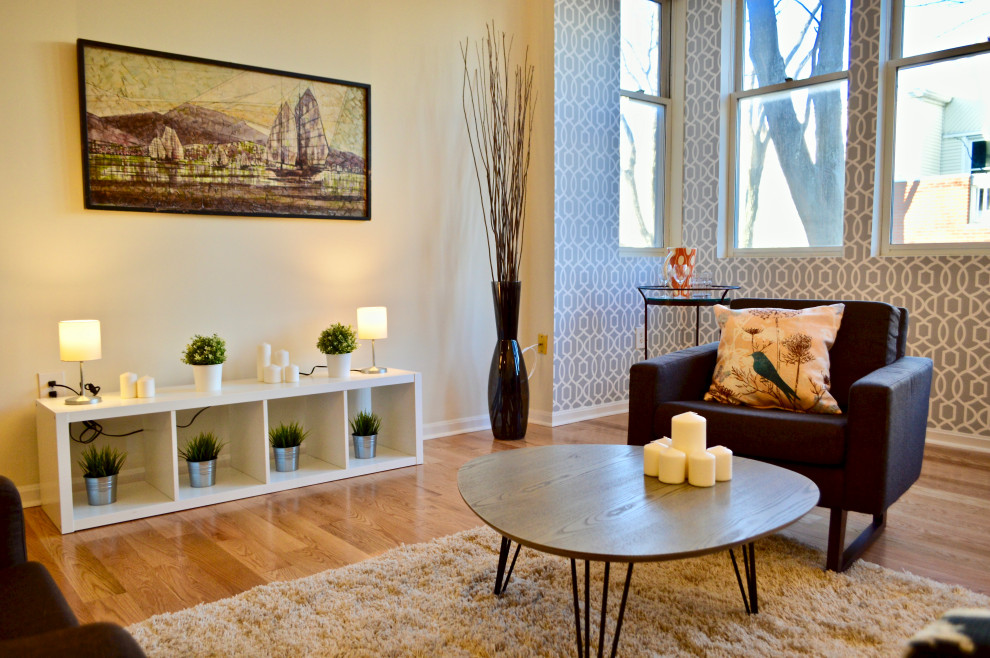 Medium sized contemporary living room in Boston with light hardwood flooring, brown floors and wallpapered walls.
